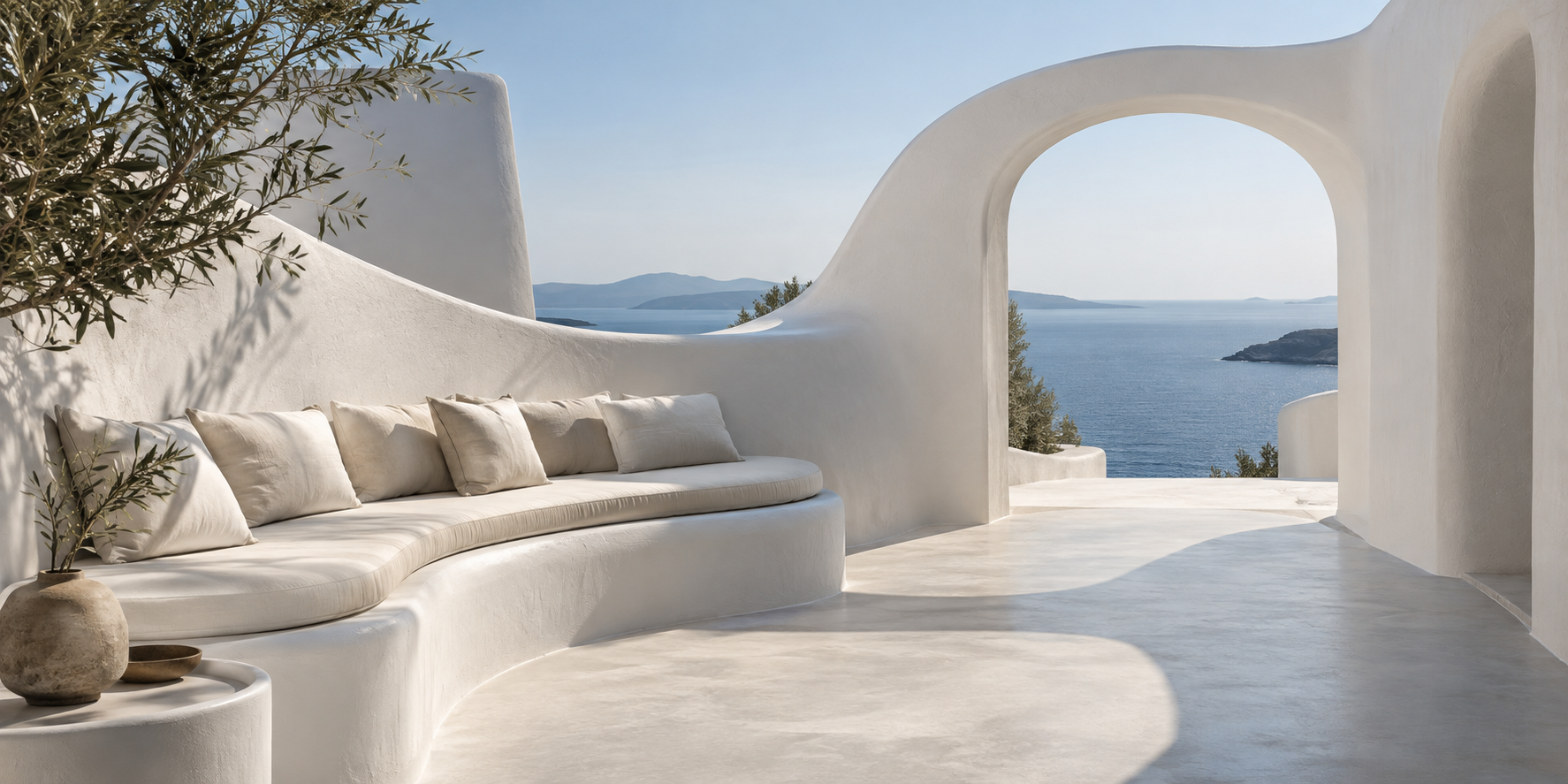 White Curves design concept: sculpted white plaster terrace and curved seating framing the Aegean sea